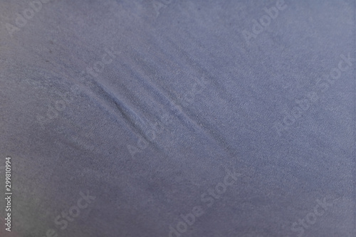 Blurred background of blue fabric with pleats