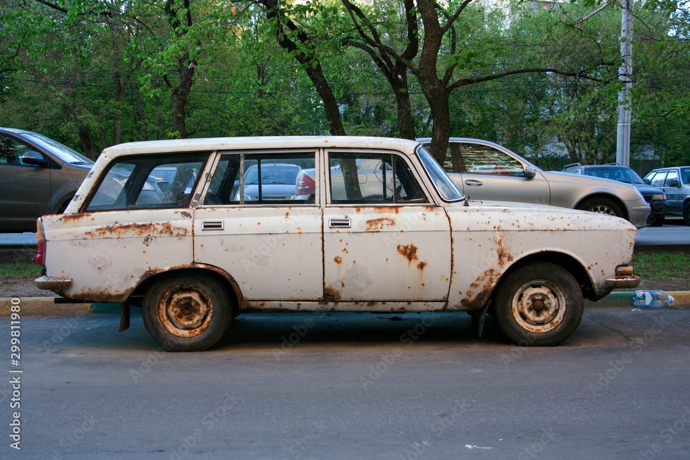 Old rusty retro car Moskvich in the Parking lot
