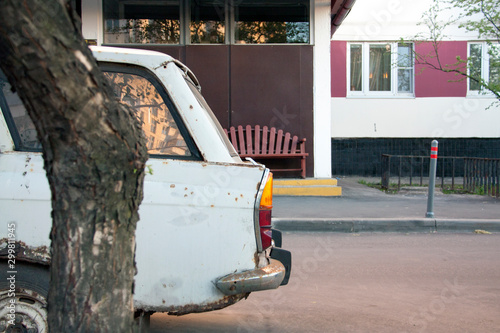 Old rusty retro car on the background of the house photo