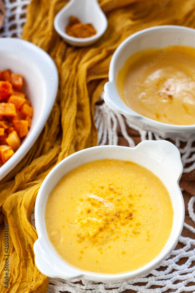 Pumpkin cream spiced with curry in a white bowl with roasted pumpkin. Close Up Pumpkin cream spiced with curry in a white bowl with roasted pumpkin. Close Up