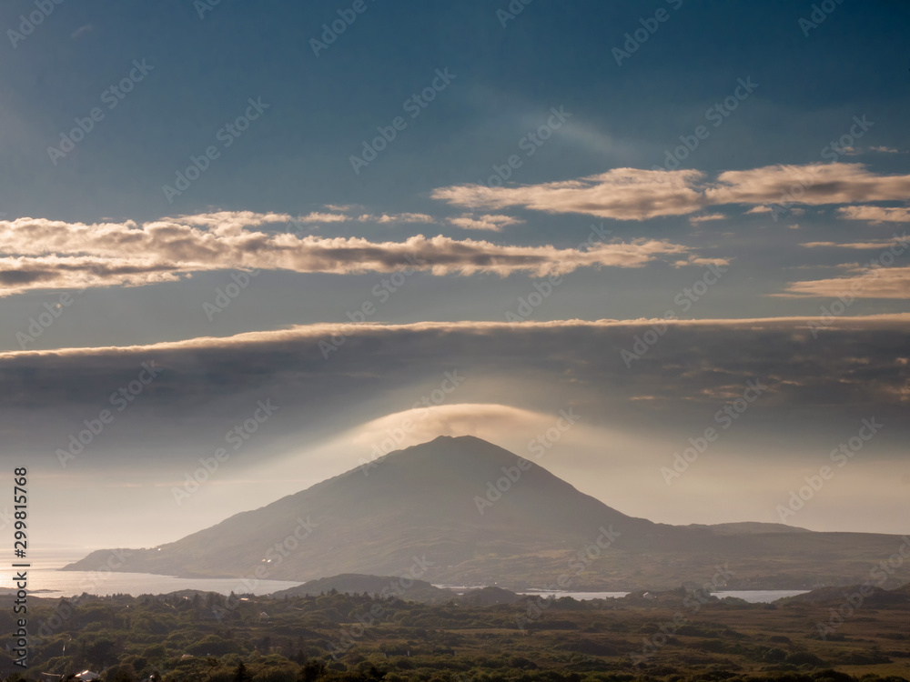 Mountain with a strange cloud over the peak, Ireland, Connemara region.
