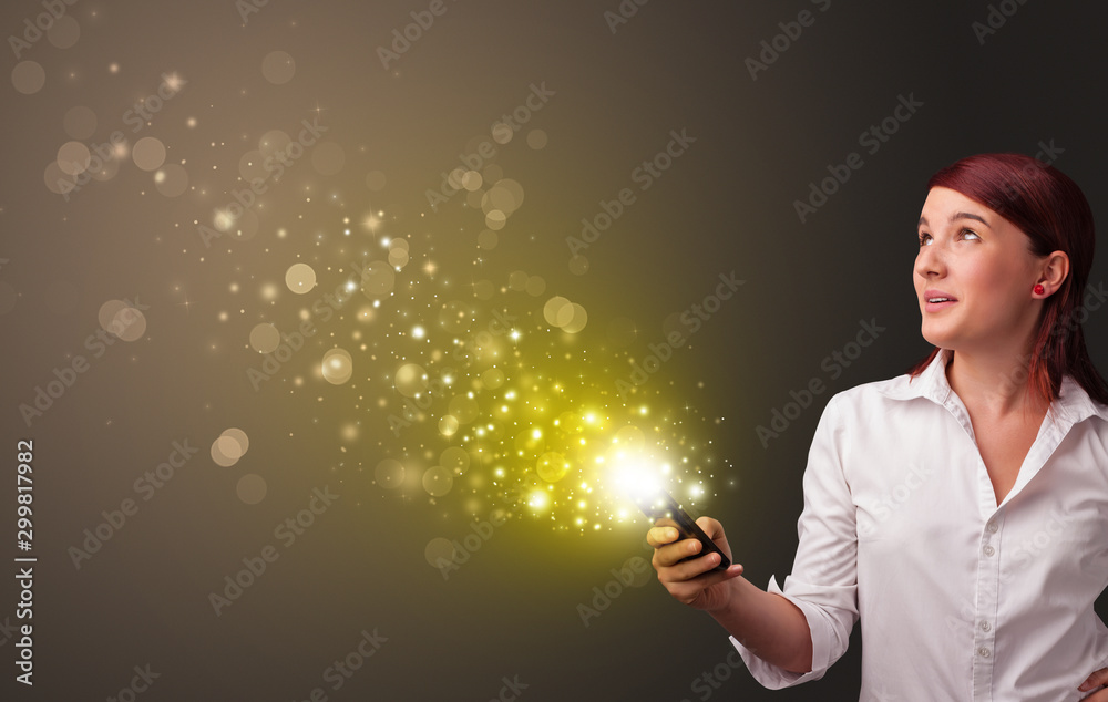 Person using phone with gold sparkling concept Person using phone with gold sparkling concept