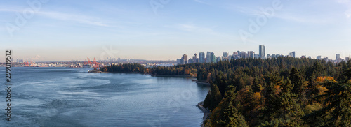 Downtown Vancouver, British Columbia, Canada. Beautiful Aerial Panoramic View of Seawall in Stanley Park with Downtown City in Background during a sunny Autumn Evening. © edb3_16