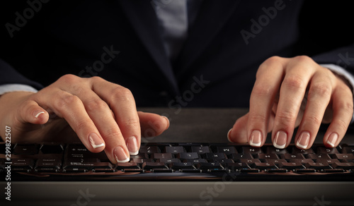 Business woman typing on keyboard © ra2 studio