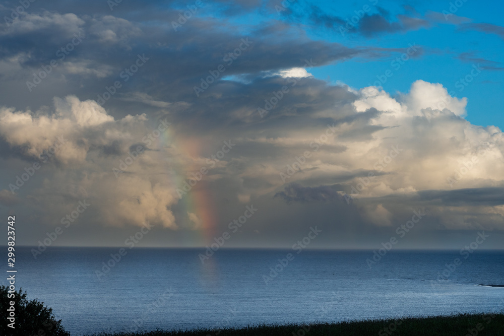 Obraz premium Beautiful storm clouds with rainbow in Whitsand bay Looe Cornwall 