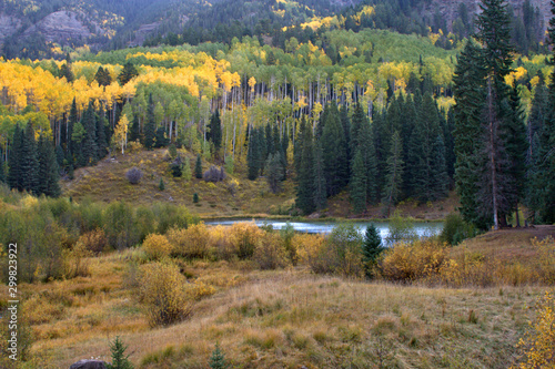 From a high vantage point a mountain lake surrounded by colorful aspen follage in the fall photo