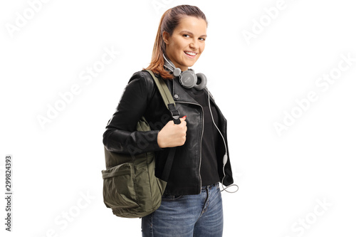 Female student with a backpack and headphones aroung her neck photo