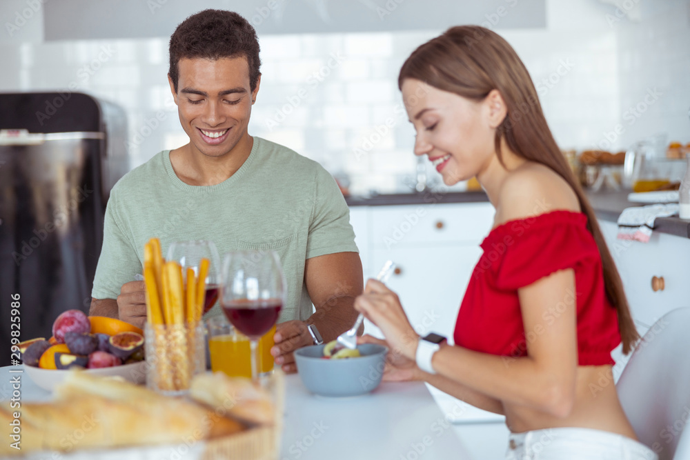 Happy international male is having romantic dinner