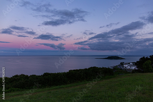 Sunset over Looe Island in Whitsand bay Looe Cornwall