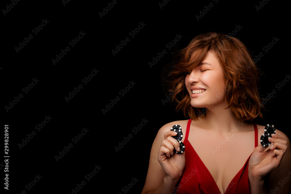 happy American Girl with a perfect hairstyle and make-up is posing with casino chips in her hands. Casino, Poker and Roulette. Gambling, young rye-haired Woman Lucky casino winnings. happy American Girl with a perfect hairstyle and make-up is posing with casino chips in her hands. Casino, Poker and Roulette. Gambling, young rye-haired Woman Lucky casino winnings.