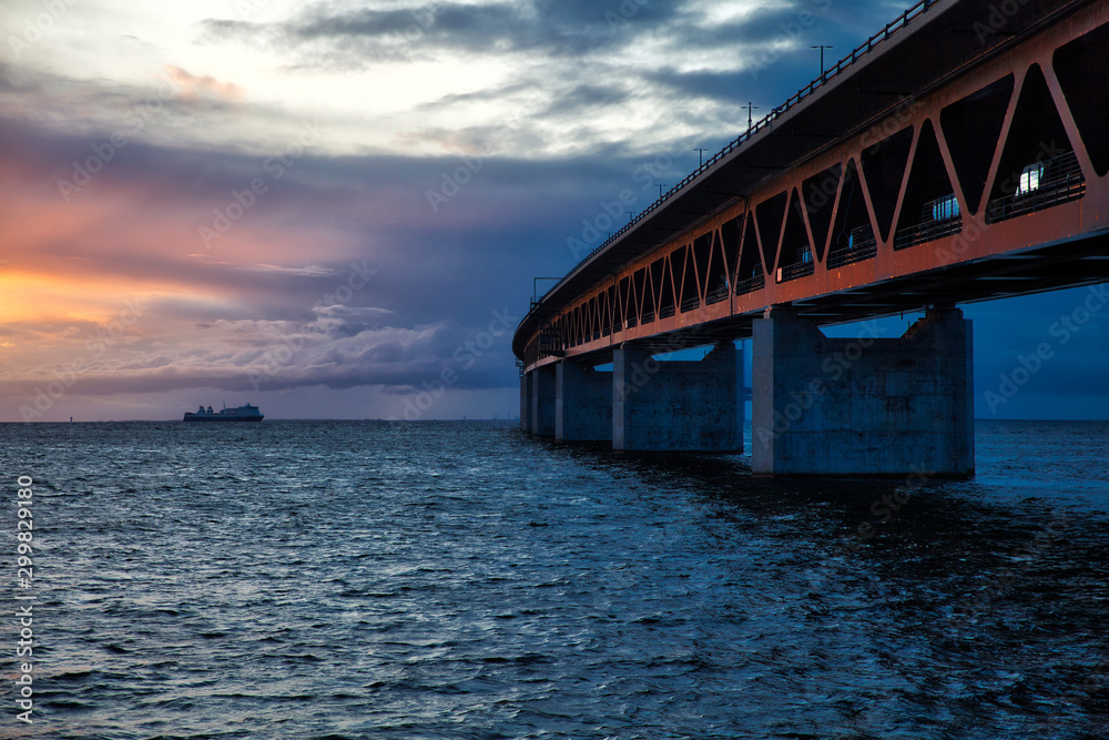 Öresund bridge with ferry and sunset  