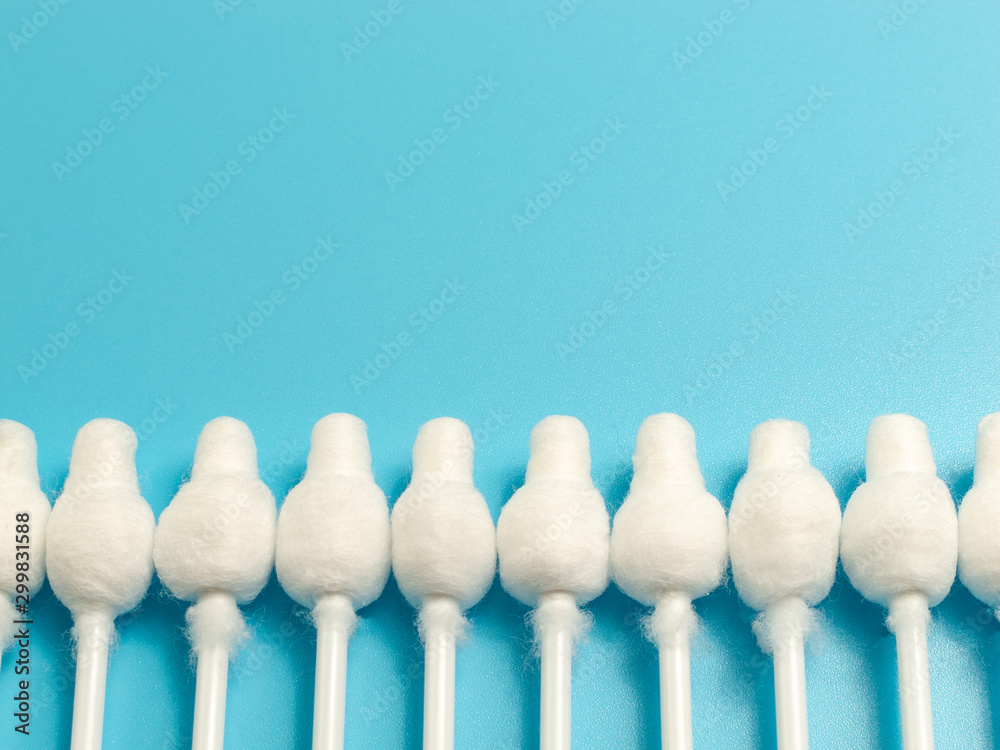 cotton buds close-up on a light blue background, for children, hygiene and ear cleaning, cotton swab cotton buds close-up on a light blue background, for children, hygiene and ear cleaning, cotton swab