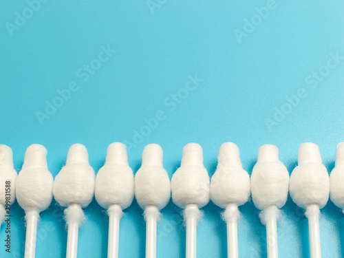 cotton buds close-up on a light blue background, for children, hygiene and ear cleaning, cotton swab