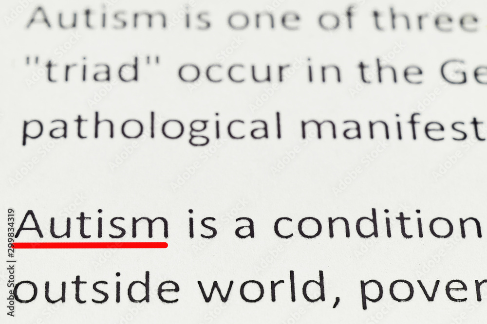 macro photography of the word autism from the newspaper macro photography of the word autism from the newspaper