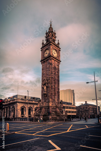 BELFAST, NORTHERN IRELAND, DECEMBER 19, 2018: People passing by Queen's Square where Albert Memorial Clock Tower is situated. Completed in 1869 and is one of the best known landmarks of Belfast.