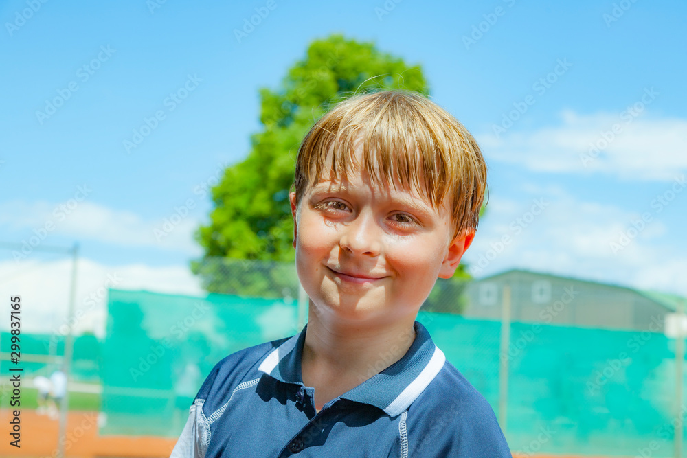 child looks happy and satisfied after the tennis match child looks happy and satisfied after the tennis match