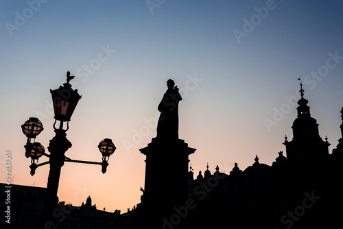 Silhouette of statue and townhall in Market Square during beautiful coloured sunset, Krakow, Poland