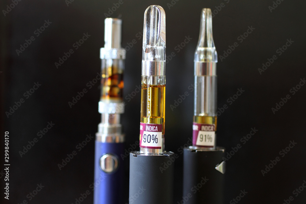 Vape pens and cartridges with a dark background. Vape pens and cartridges with a dark background.