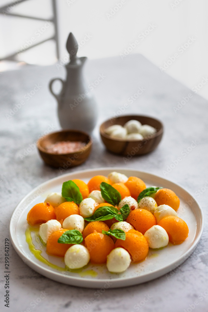 High angle view of salad by mozzarella and salt on table High angle view of salad by mozzarella and salt on table
