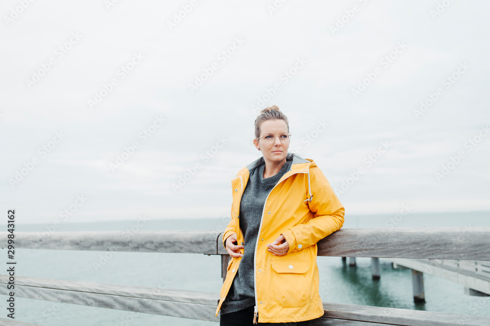 Young woman wearing yellow rain coat Young woman wearing yellow rain coat