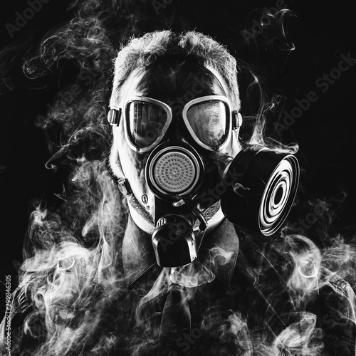 a man in a suit gas mask and smoke photo
