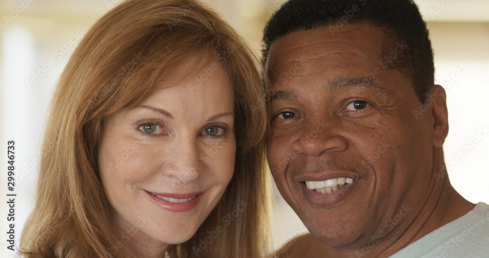 Close up portrait of smiling mixed race senior couple looking at camera Close up portrait of smiling mixed race senior couple looking at camera