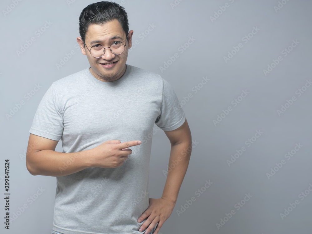Asian Man Presenting Something on His Side with Copy Space Asian Man Presenting Something on His Side with Copy Space