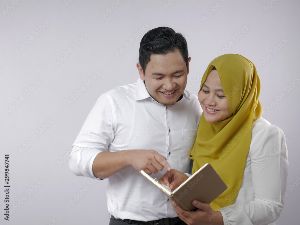 Muslim Couple Analyzing Financial Management Report Muslim Couple Analyzing Financial Management Report