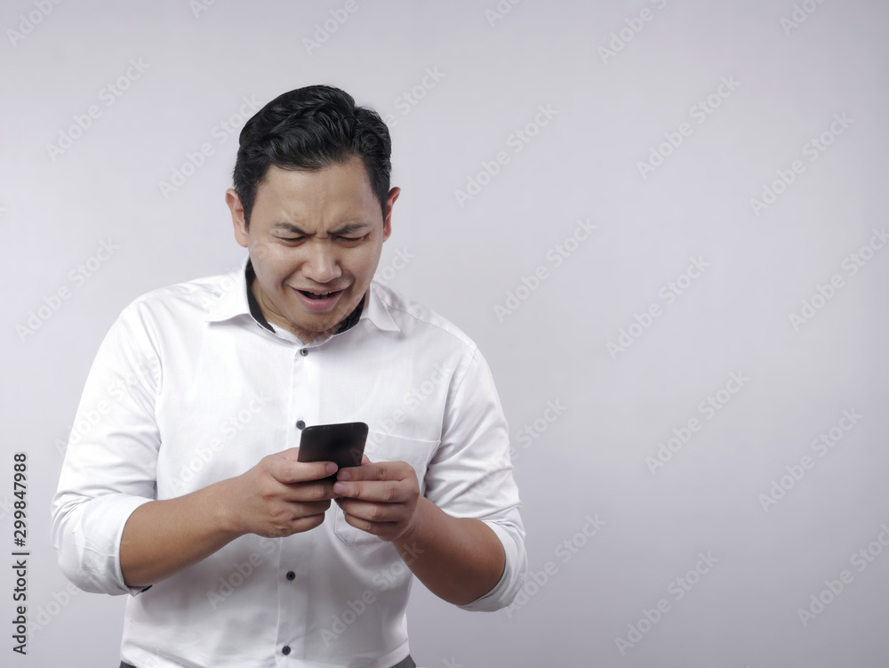 Young Man Texting Reading Chatting on His Phone Sad Crying Young Man Texting Reading Chatting on His Phone Sad Crying