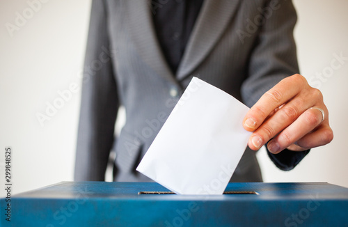 elections - The hand of woman putting her vote in the ballot box