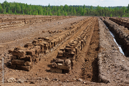Pile of stacked bog peat turf briquette photo