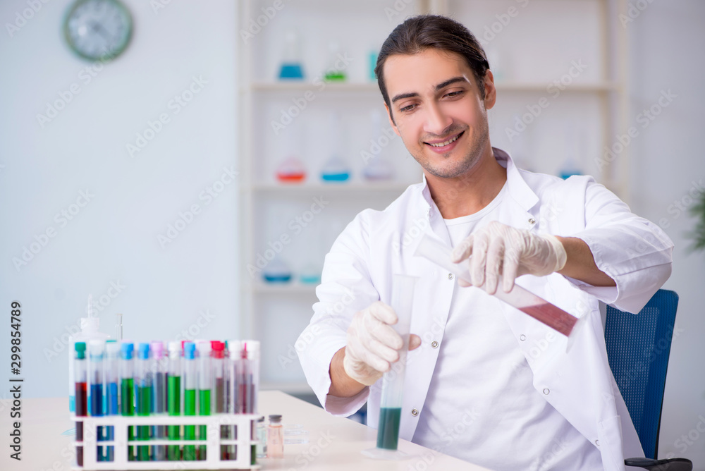Young male chemist working in the lab Young male chemist working in the lab