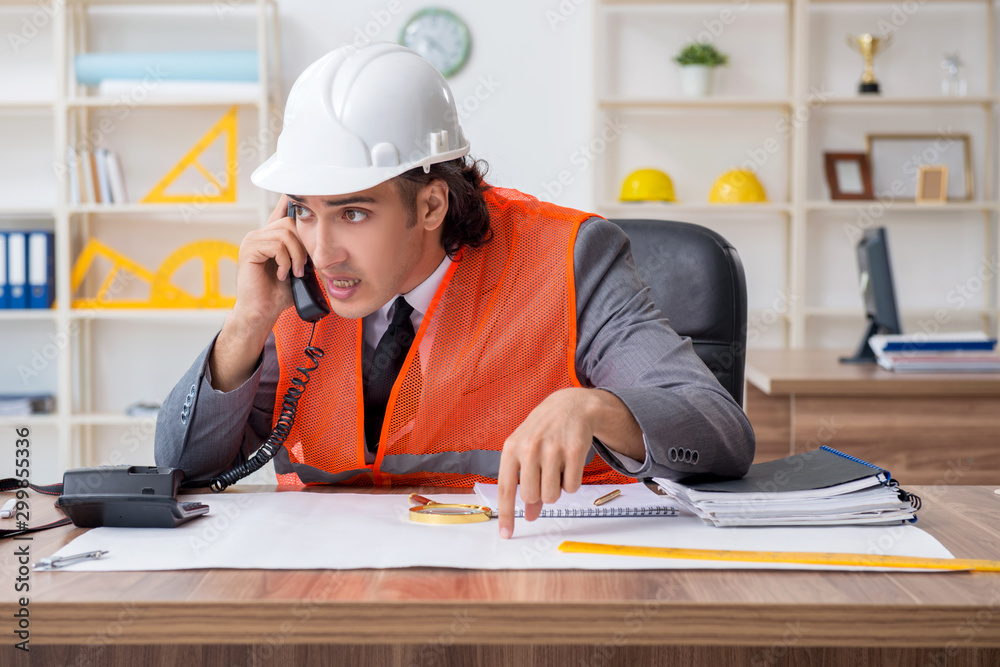 Young male architect working in the office