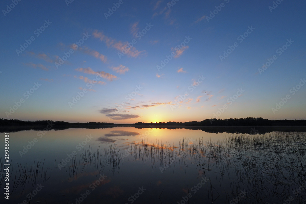 Colorful sunrise clouds and reflections on Nine Mile Pond in Everglades National Park, Florida in winter.