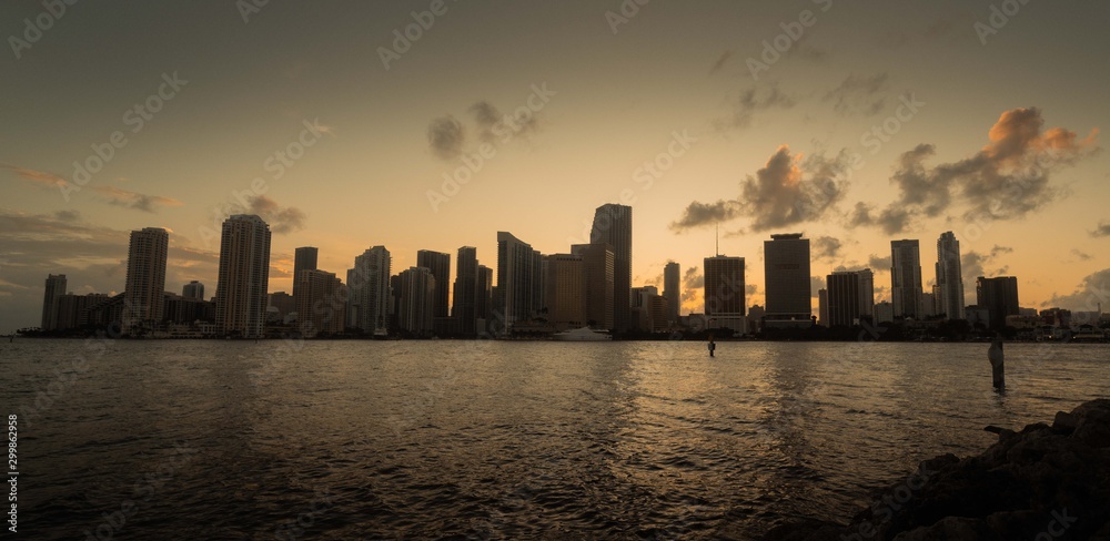 buildings view sea sky clouds lights water sunset miami