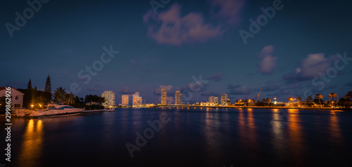 buildings view sea sky clouds lights water sunset miami