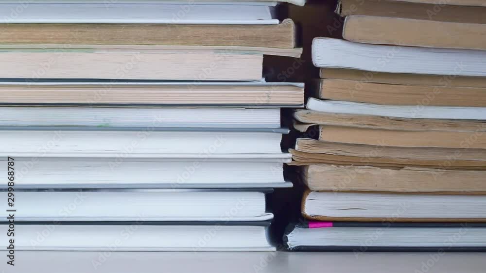 Dolly sliding shot along book stacks. Moving from left to right along book shelve. The books are stacked. Books are on the bookshelf close up Dolly sliding shot along book stacks. Moving from left to right along book shelve. The books are stacked. Books are on the bookshelf close up