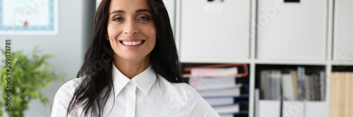 Business woman in white shirt against office