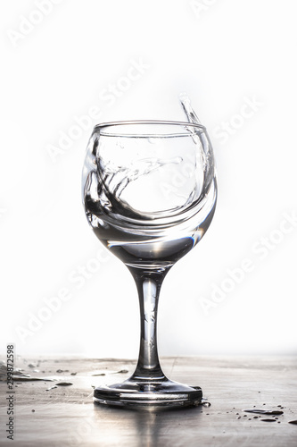 Water splash from a glass on a white background
