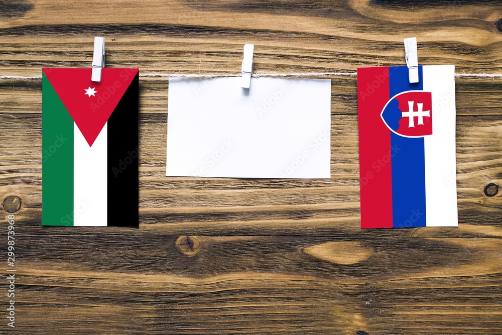 Hanging flags of Jordan and Slovakia attached to rope with clothes pins  with copy space on white note paper on wooden background.Diplomatic  relations between countries. Stock Photo | Adobe Stock