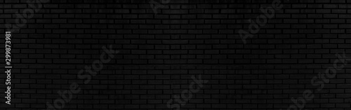 Abstract black brick wall texture for background or wallpaper design. panoram...