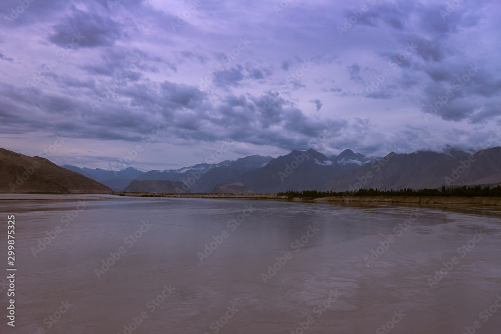 landscape view of the Indus river flowing through Katpana cold desert in Skardu, Gilgit Baltistan, Pakistan.