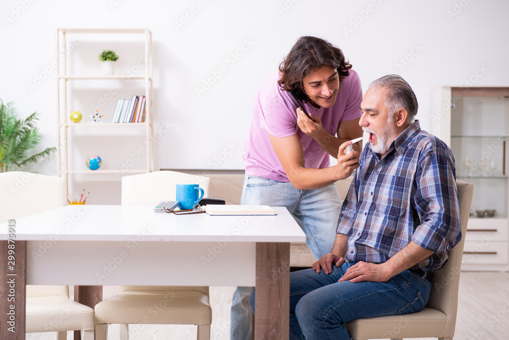 Young student and his old grandpa at home