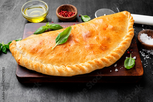 Homemade fresh baked closed calzone pizza. Italian food.