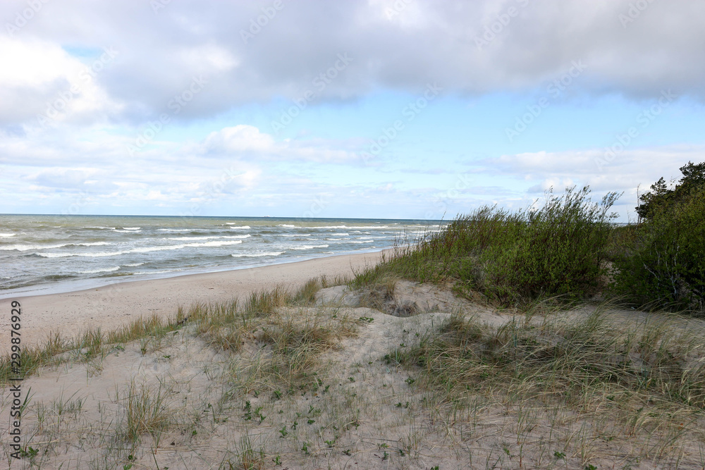 Waves, blue sky and baltic sea sand dunes, Palanga, Lithuania