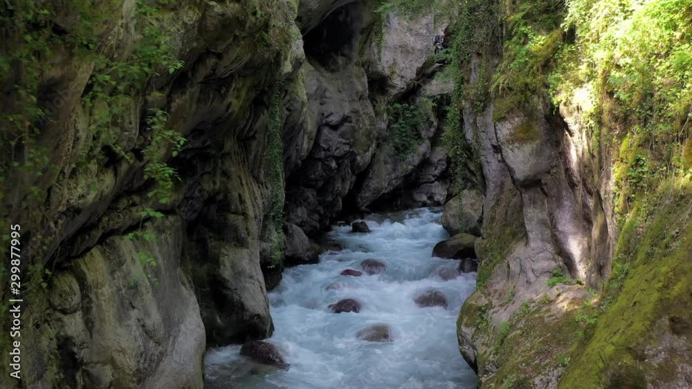 Drone moving over flowing water amidst rock formation in forest - Alpes-Maritimes, France Drone moving over flowing water amidst rock formation in forest - Alpes-Maritimes, France
