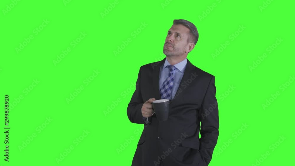 Caucasian businessman thinking idea while drinking a cup of hot coffee. Shot in 4k resolution with green screen background Caucasian businessman thinking idea while drinking a cup of hot coffee. Shot in 4k resolution with green screen background