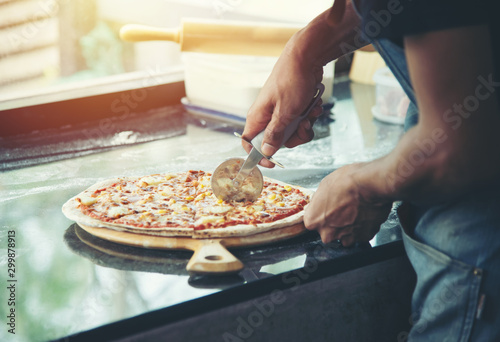 hand Chef preparing spread cheese on pizza on marble table