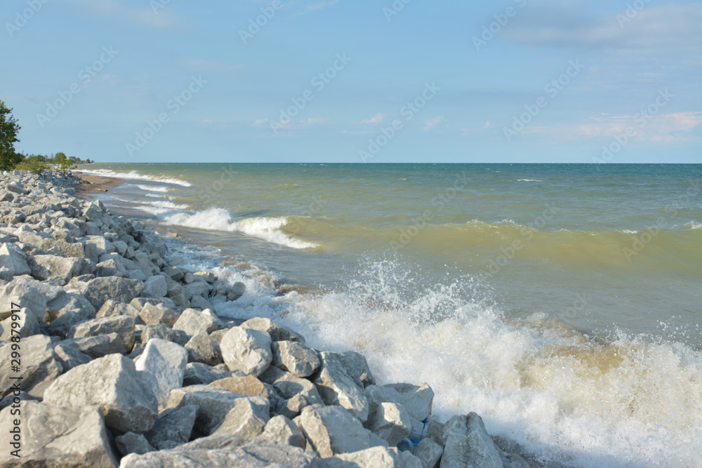 Afternoon splashing waves on beach rocks Afternoon splashing waves on beach rocks