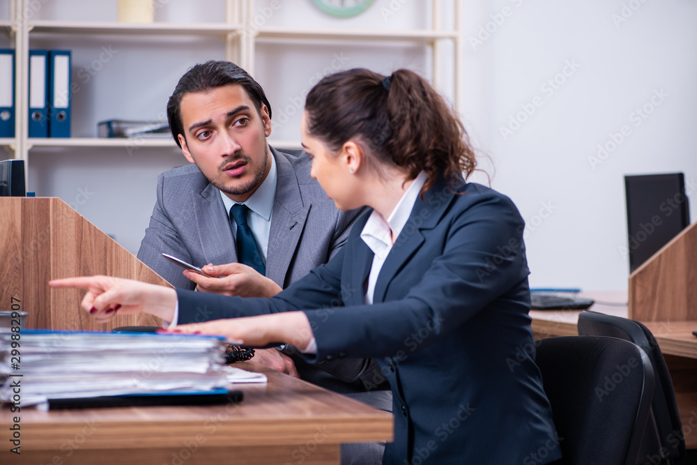 Two employees working in the office Two employees working in the office